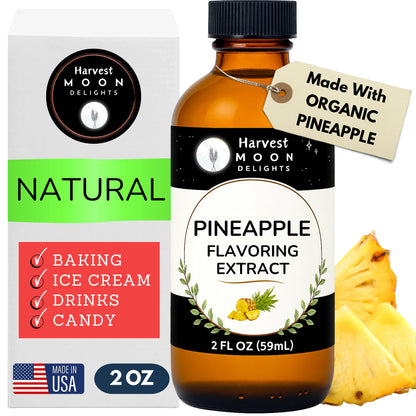 Harvest Moon Delights pineapple flavoring extract bottle with packaging and a pineapple on a white background
